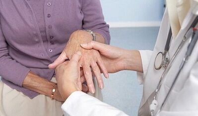 the doctor examines the joints of the hands with osteoarthritis and arthritis