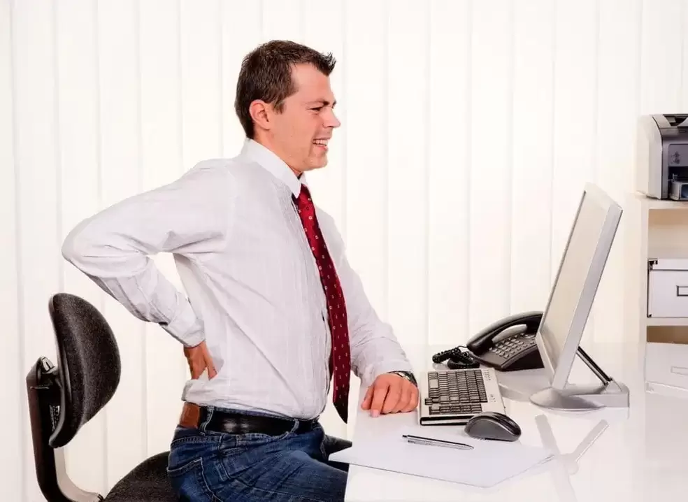 Back pain due to osteochondrosis during sedentary work.